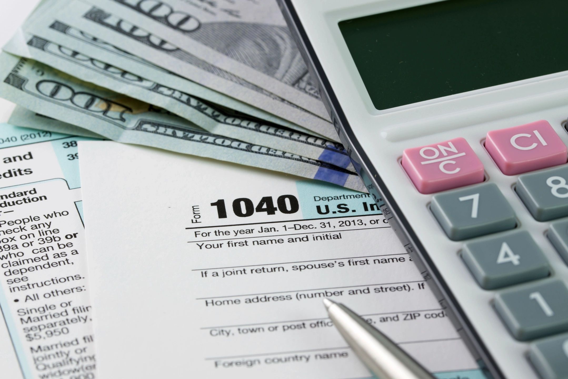 Calculator and tax forms with cash