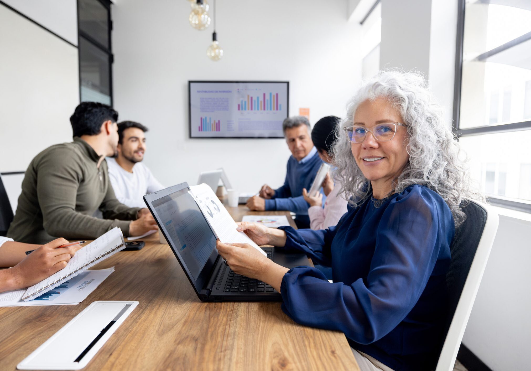 Happy Latin American businesswoman smiling in a business meeting at the office and looking at the camera