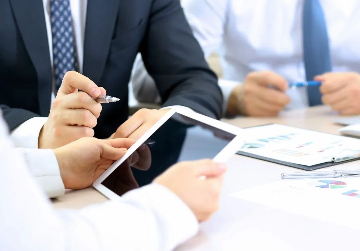 Professionals reviewing data on tablet