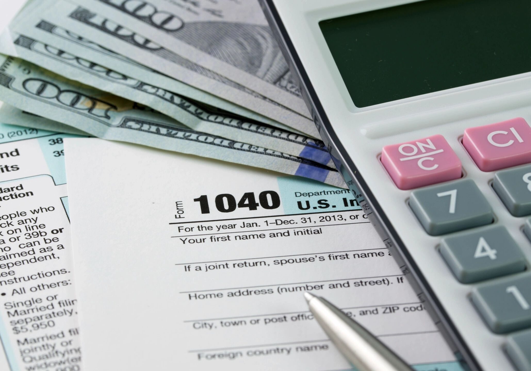 Calculator and tax forms with cash