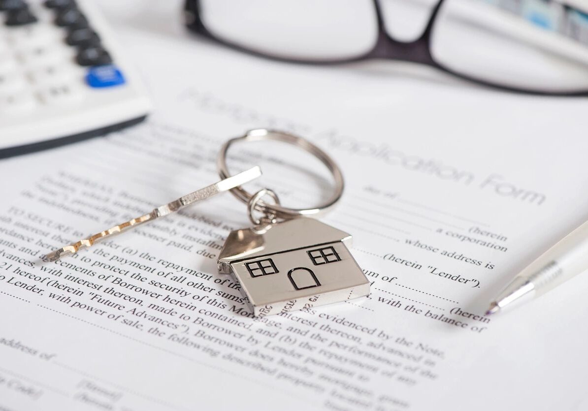 Real estate paperwork with house keychain