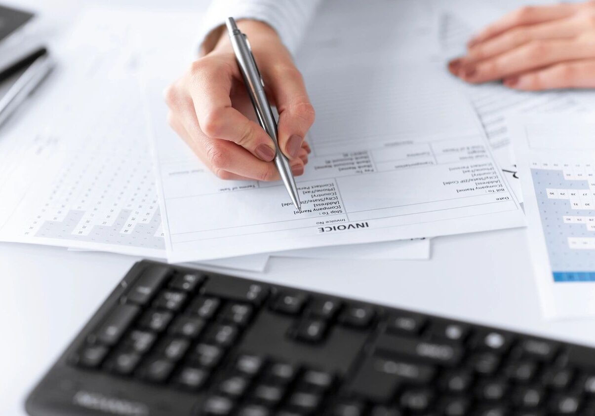 Person filling out financial documents